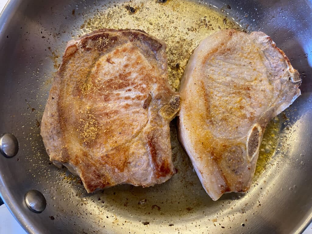 Seared pork chops in a pan